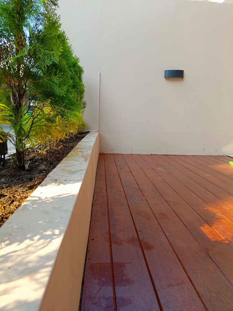 A,Wooden,Deck,Adorned,With,Various,Potted,Plants,Creates,A